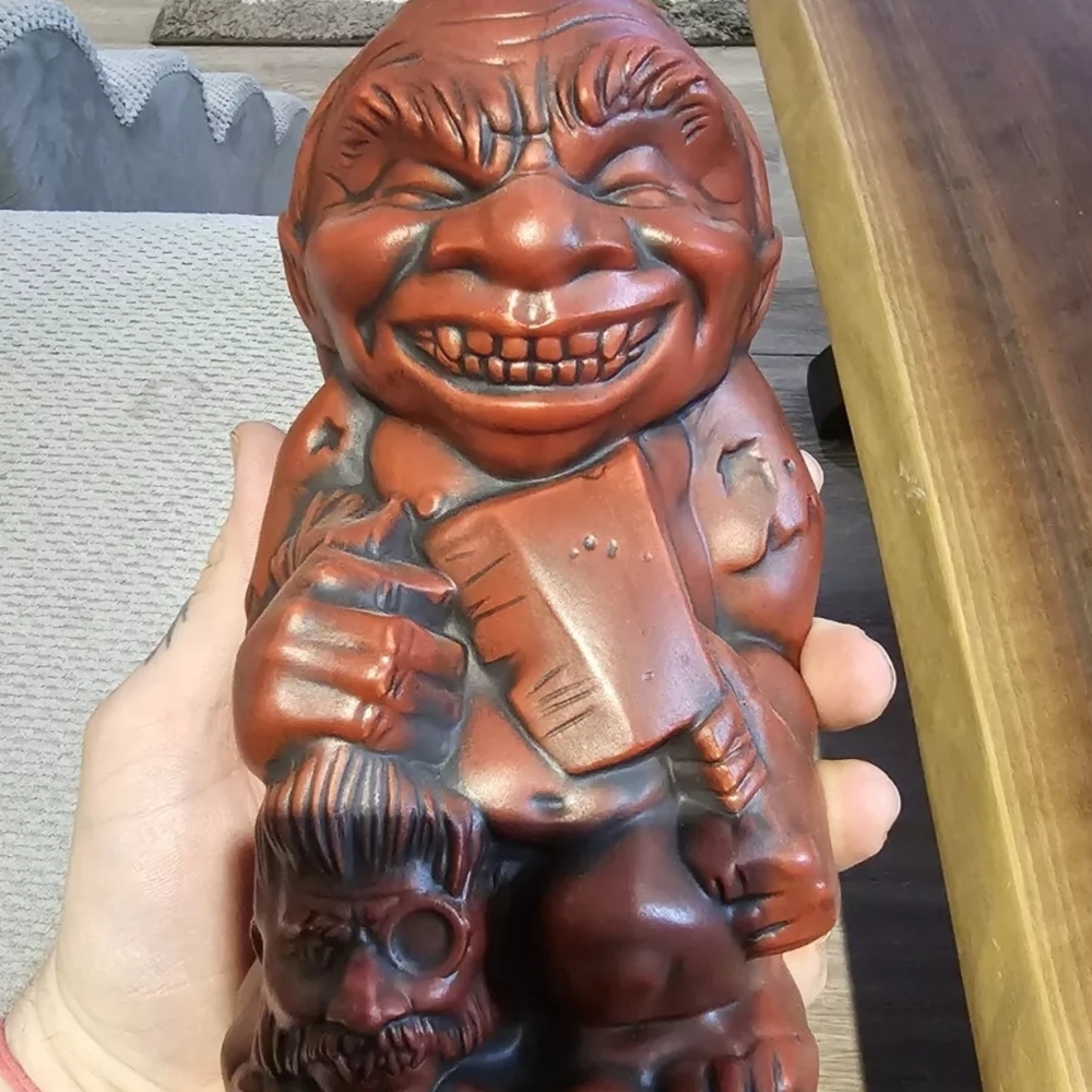 Red Grinning Figurine with Axe